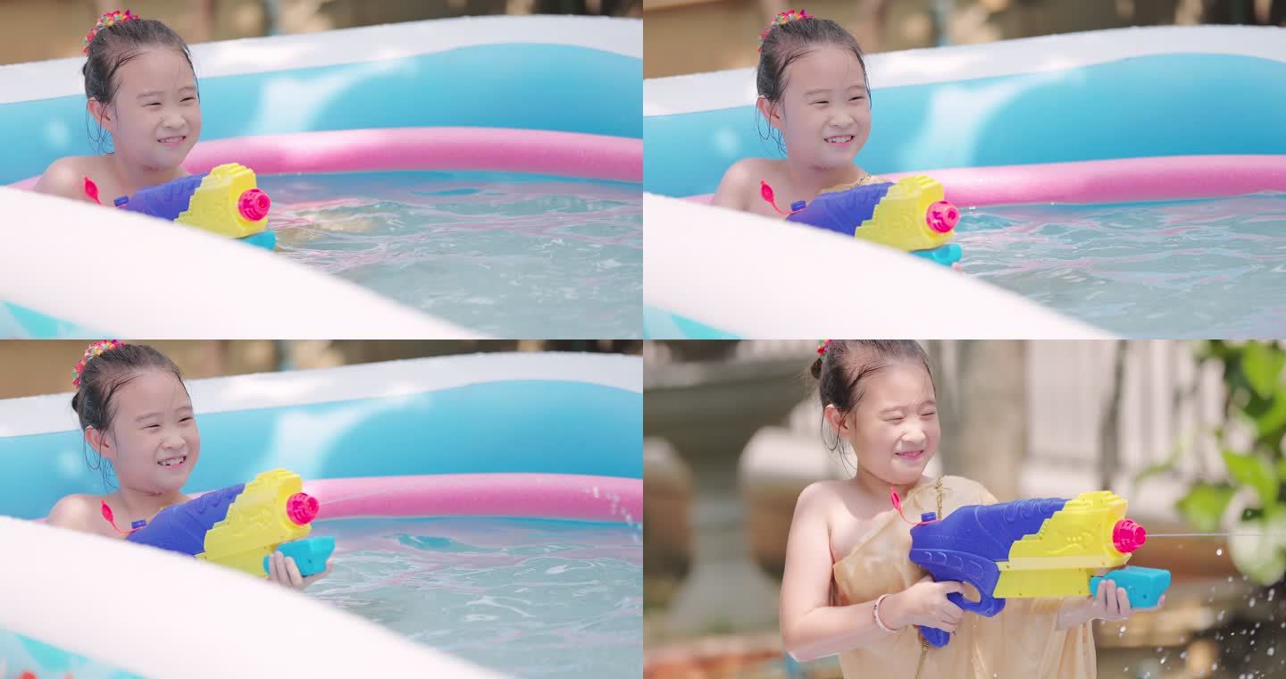 夏季，穿着泰国传统服装的亚洲小女孩在游泳池里玩水枪