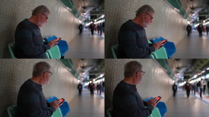 老年人在等地铁列车时使用手机
