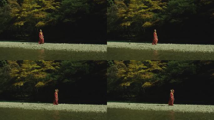 藏族女子河边行走