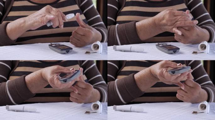 西班牙裔老年妇女用手指上的柳叶刀通过血糖仪检查血糖水平的特写镜头