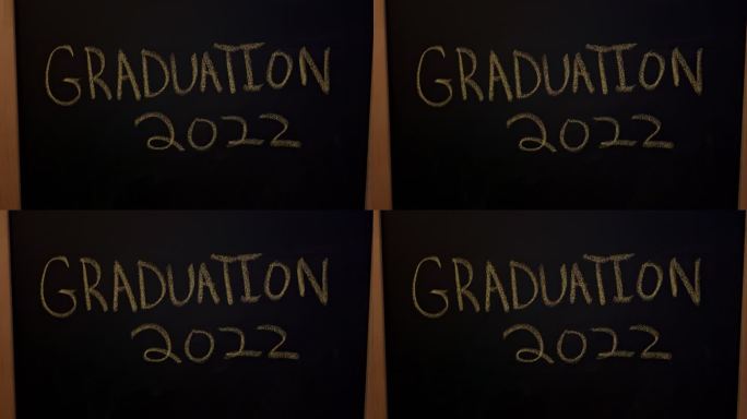 大型黑色黑板，上面用黄色粉笔写着“毕业2022”并下划线