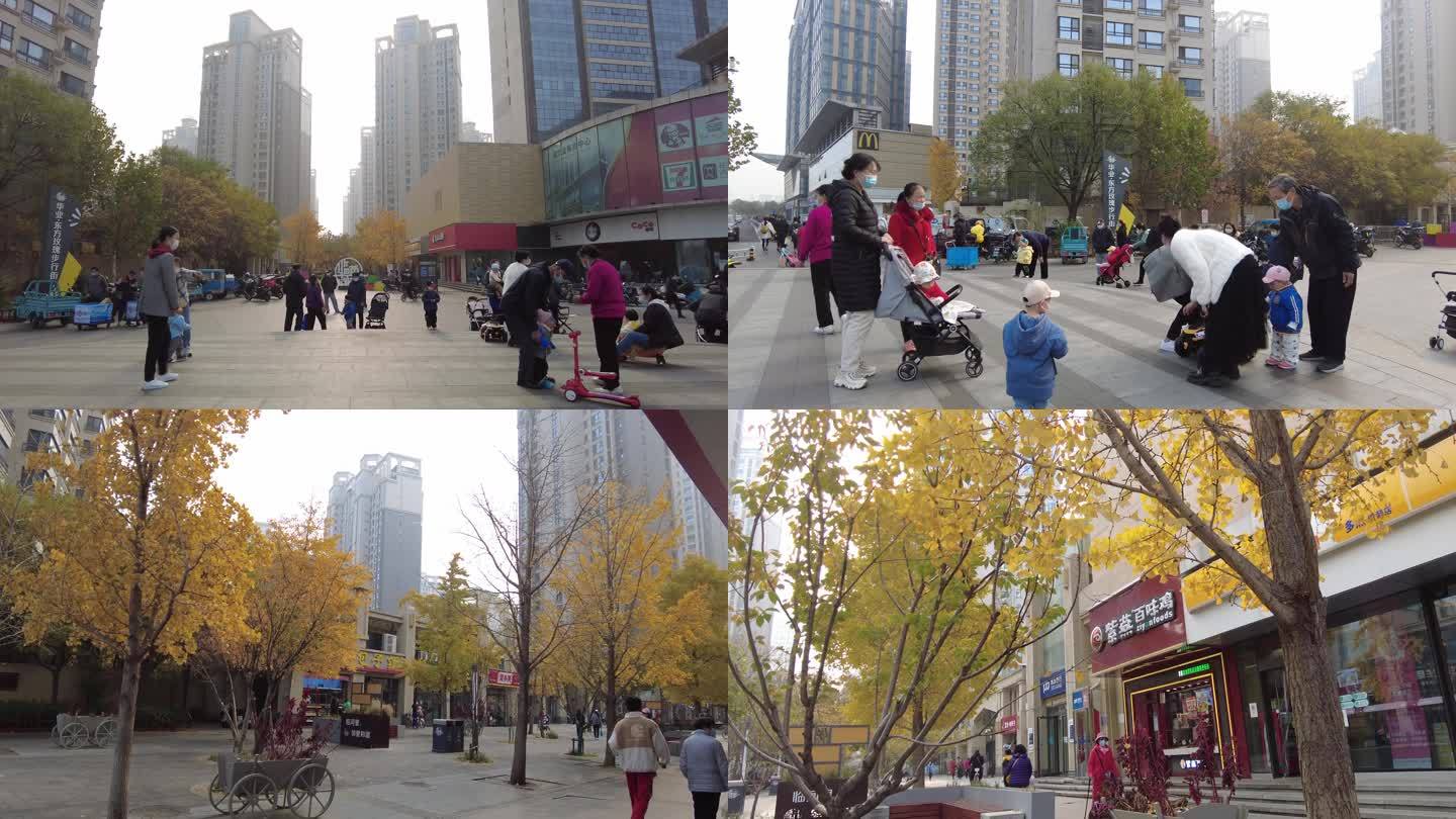 城市人文步行街街景带孩子小区居民深秋季节