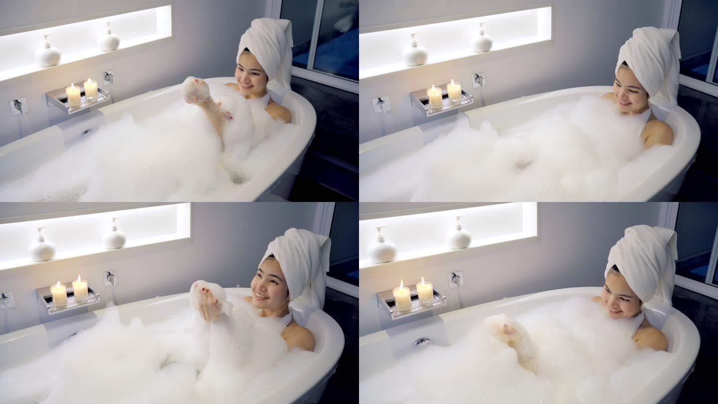 4K镜头特写女人在浴缸里洗澡，玩泡泡。