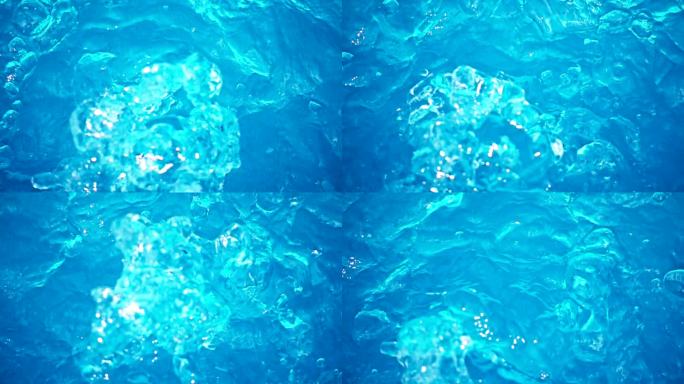 蓝色游泳池的水在慢动作中流动和飞溅