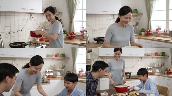 特写：微笑的亚洲母亲从厨房炉子里端起一锅汤，放在餐桌上。当父子俩看着时，她用手扇着扇子闻香气
