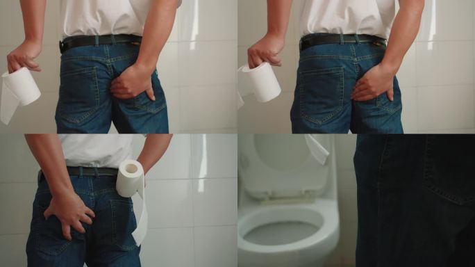 男子手拿厕纸痔疮发作屁股疼