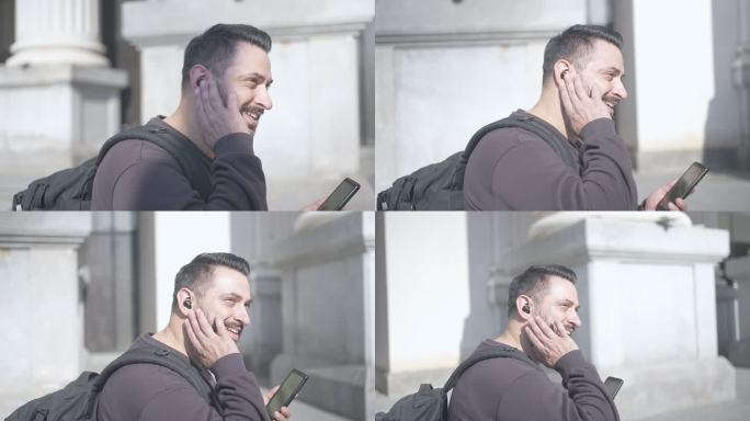 男性在智能手机通话中使用免提设备微笑的慢动作视频