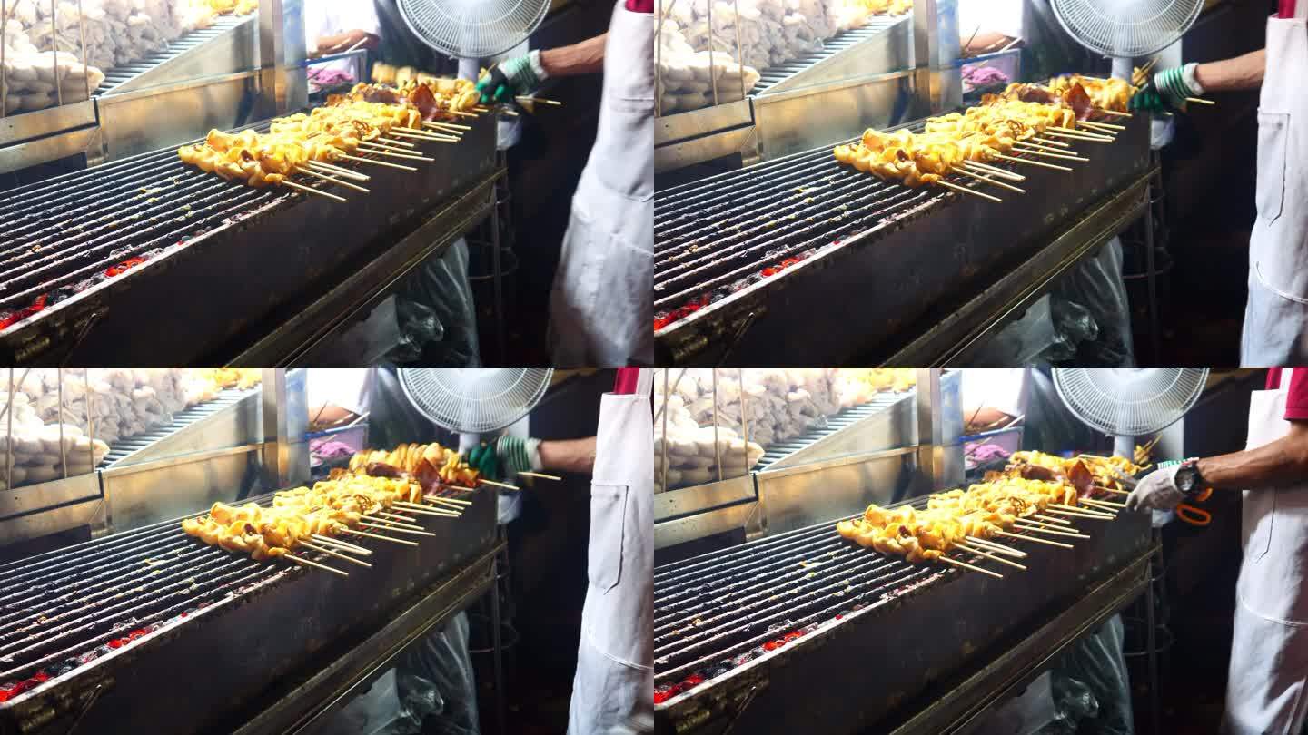 晚上在泰国街头美食的木炭炉上烤鱿鱼