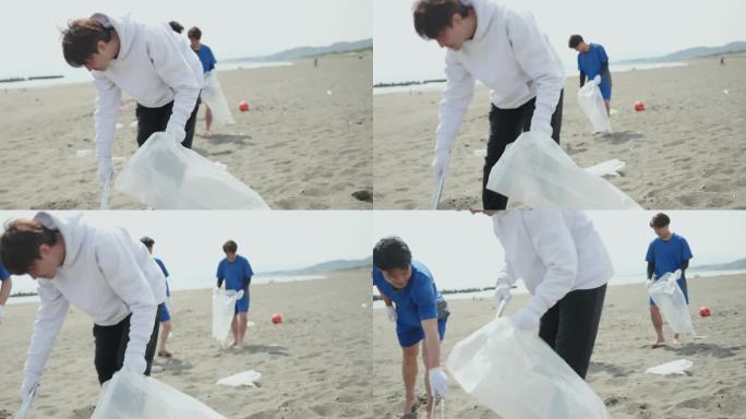 亚洲运动队队员清理海滩上的塑料瓶和垃圾