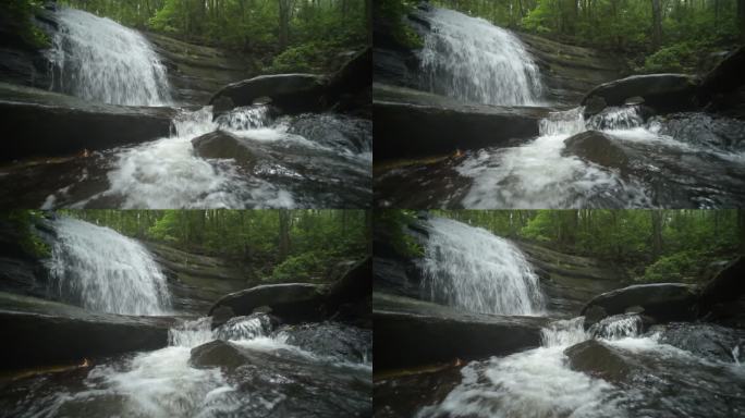 水顺着瀑布倾泻而下，流向相机下方