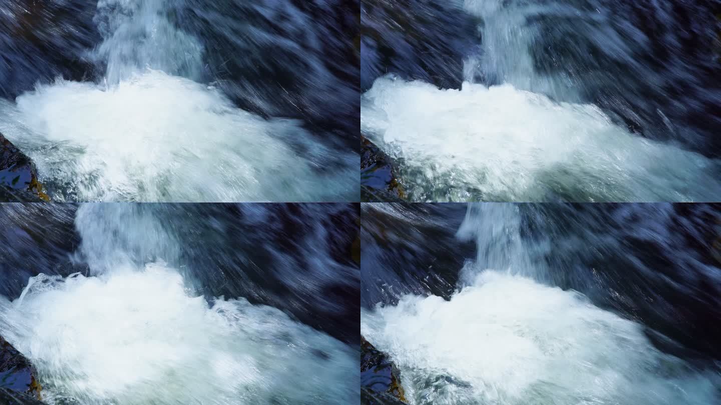 从岩石和巨石上的山涧瀑布流出的水的视频片段