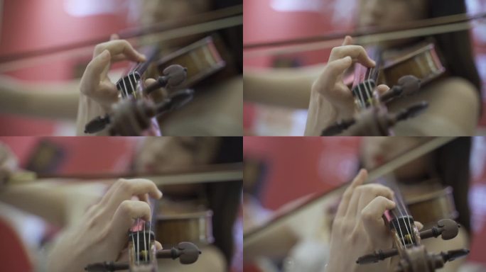 拉小提琴正在演奏小提琴的女孩手指特写