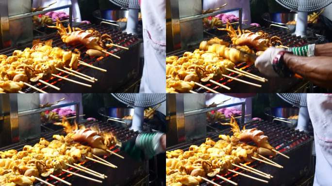 晚上在泰国街头美食的木炭炉上烤鱿鱼