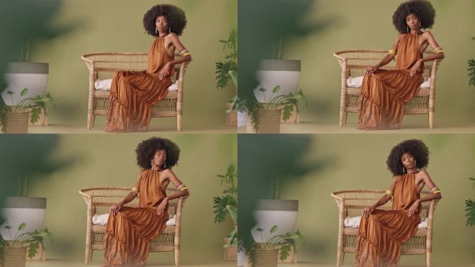 全身美貌的非洲裔女性，一个黑人独自坐在柳条椅上，自信满满。强大而充满异国情调的黑人女性，在演播室里摆