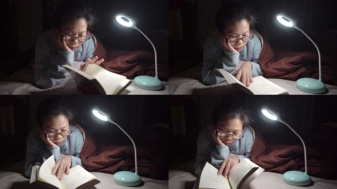 亚洲女人晚上在床上看书