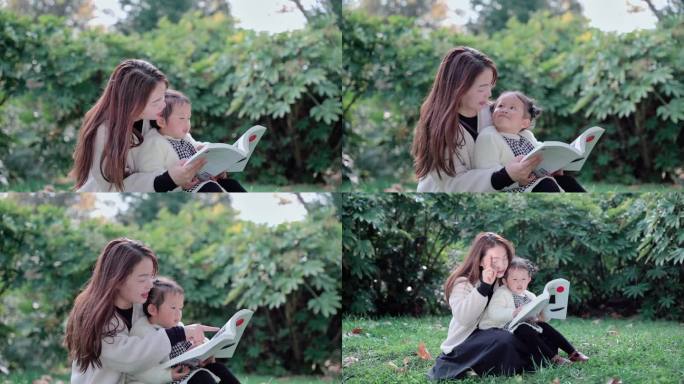草地上妈妈抱着女儿在亲子阅读