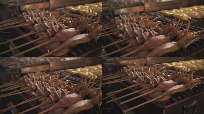 特写煤炉上的烤鱿鱼，泰国曼谷尧瓦拉特的亚洲街头美食