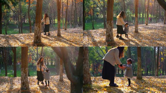 年轻妈妈与女儿在金黄落叶上拉手跳舞