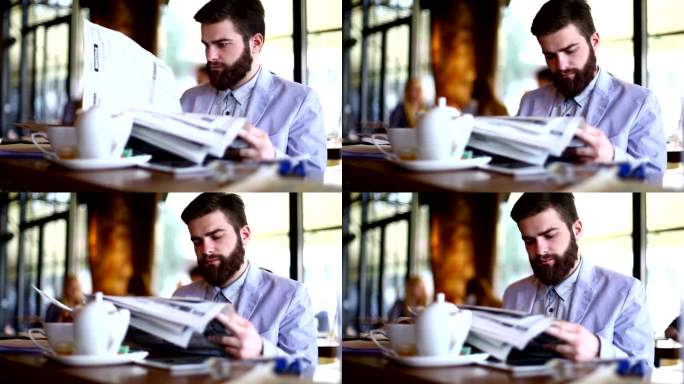 男人在看报纸。咖啡悠闲看报阅读热饮报纸