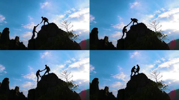登山者相互协助勇攀高峰成功登顶