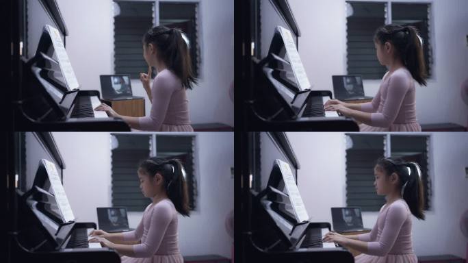 一个亚洲小女孩在线学习钢琴。