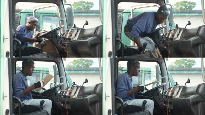 年轻的非裔美国人驾驶卡车阅读剪贴板