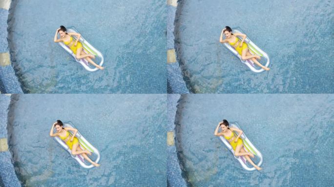 航拍美女在游泳池惬意享受阳光素材