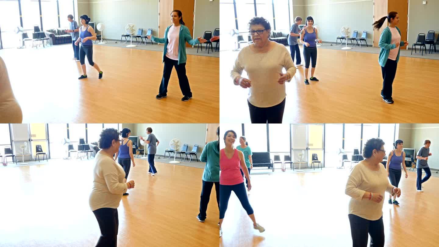 活跃的老年和年轻女性学习排舞