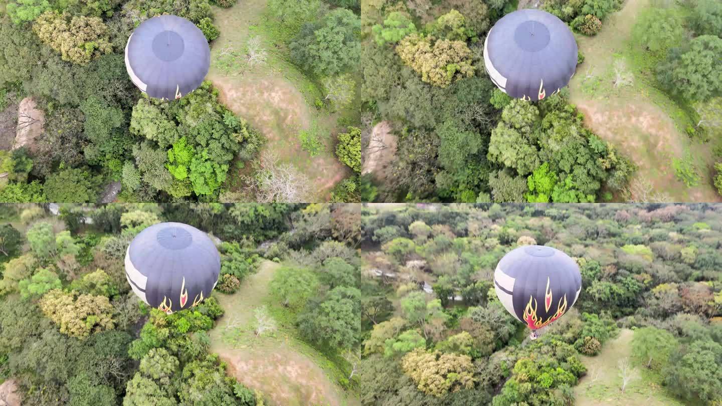 这名男子驾驶一架无人机从上方沿着热气球的路径飞行