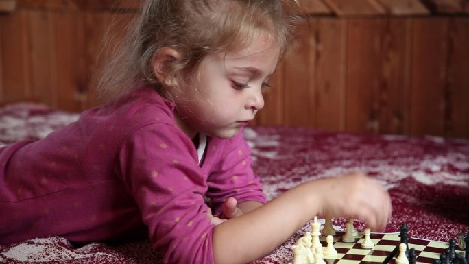 小女孩在床上下棋儿童下国际象棋陪伴玩耍童