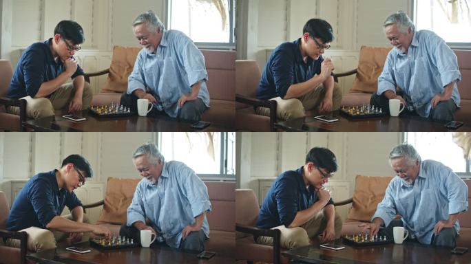 亚洲老父亲和小儿子在家一起下棋