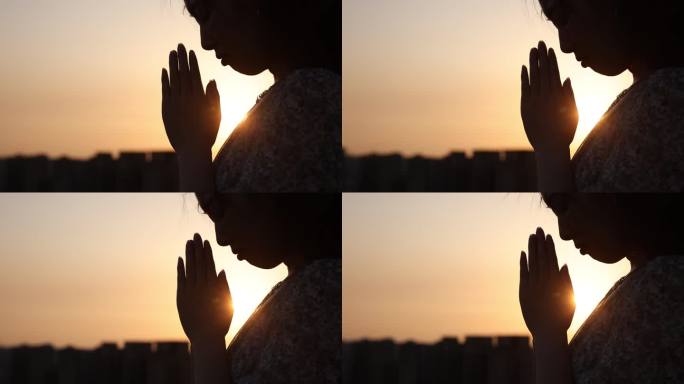 女人用阳光祈祷平安祝愿双手合十