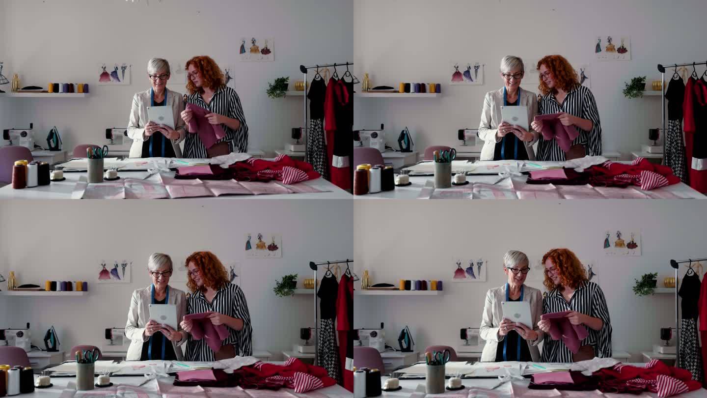 女性时装设计师看数码平板电脑