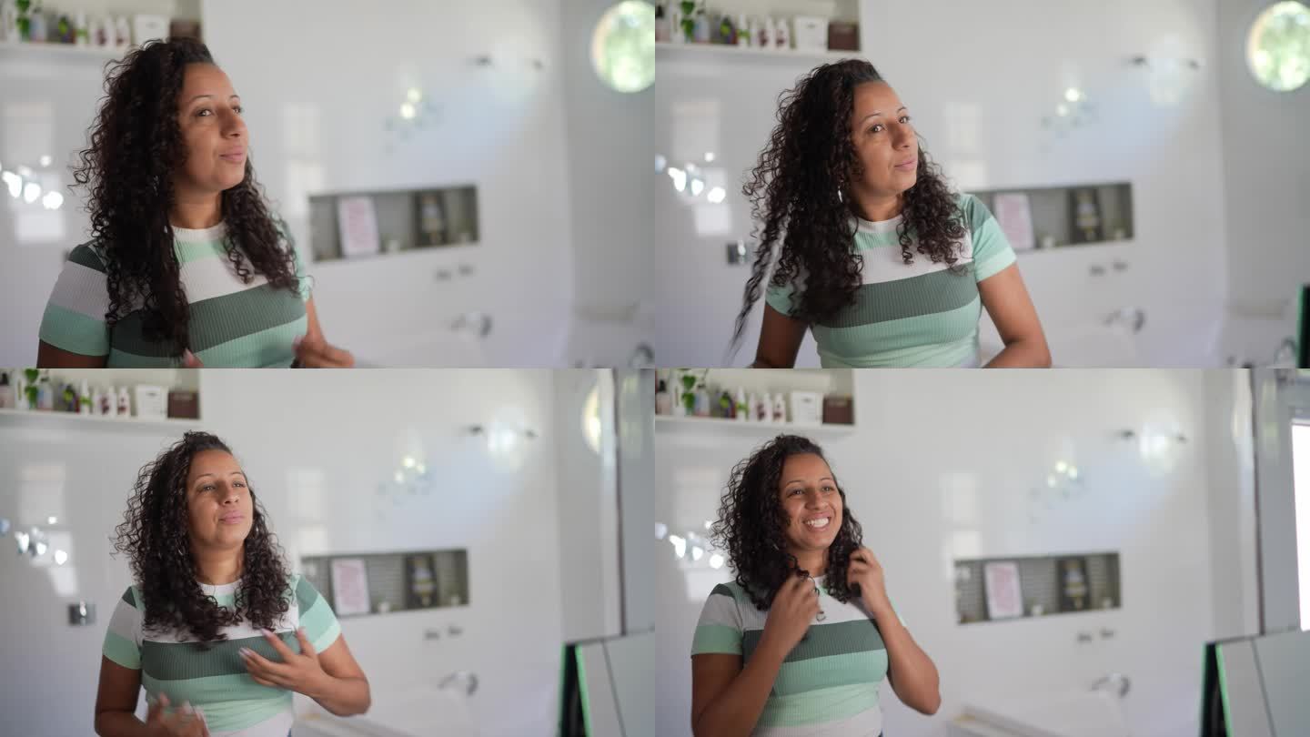 女人在家照着镜子打理头发