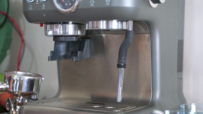 一位咖啡师在使用咖啡机制作浓缩咖啡