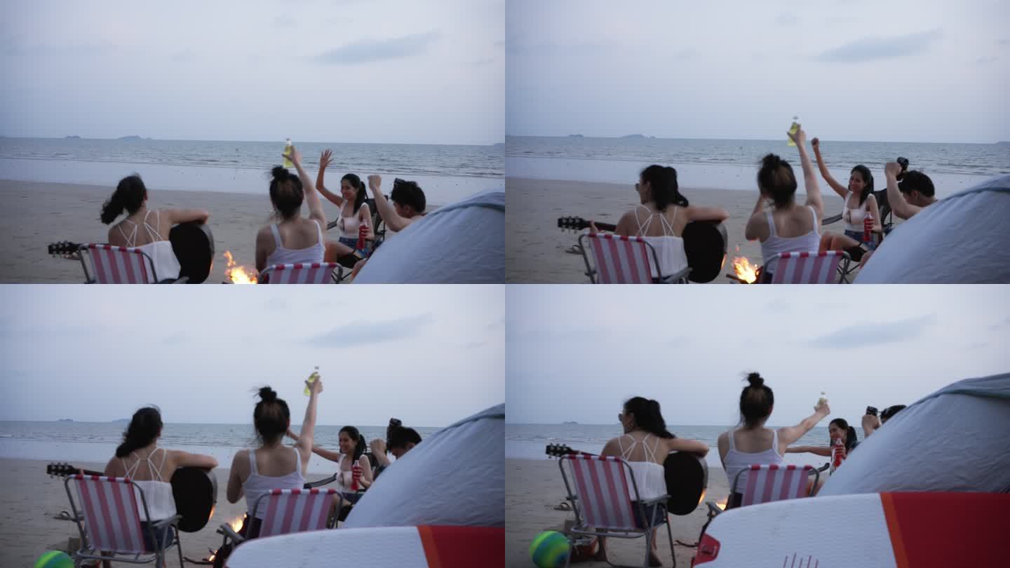 一群亚洲朋友在海滩上露营度假。