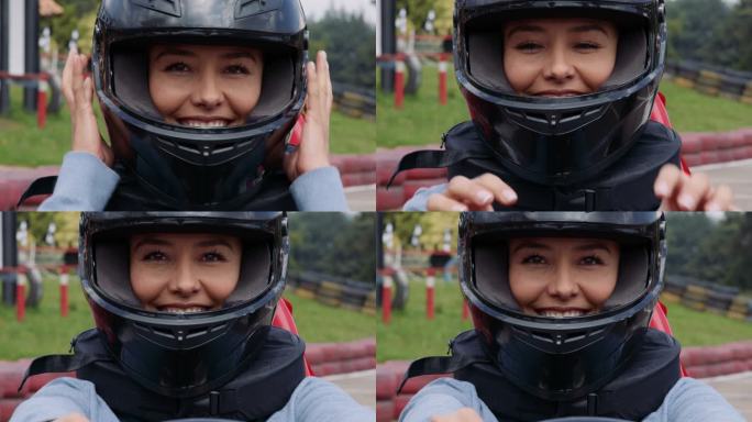 一个美丽快乐的女人在一个手推车赛道上面对镜头微笑时，确保头盔正确佩戴的视频肖像