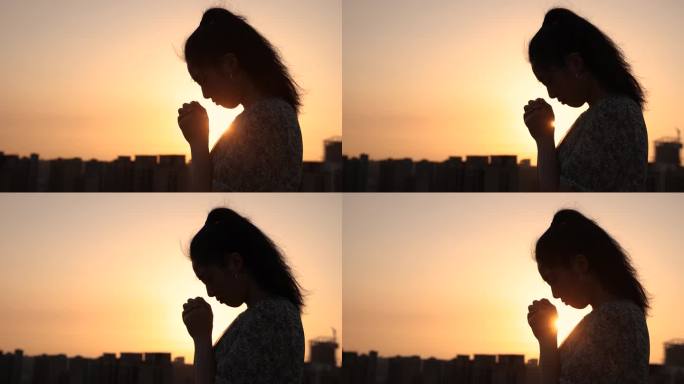 女人用阳光祈祷女人用阳光祈祷日落夕阳剪影