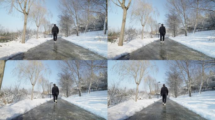 4k慢动作 男子雪中小路行走前进背影