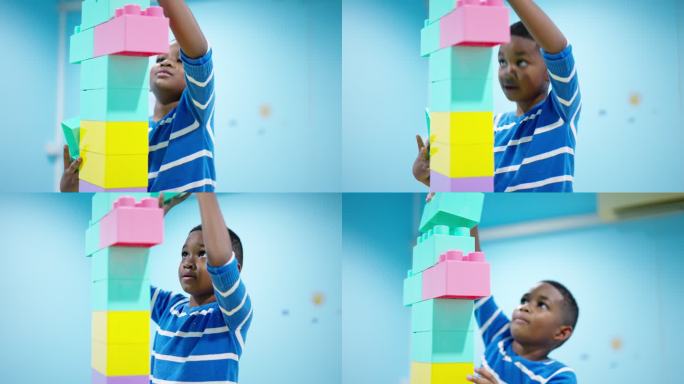 聚焦于非洲黑人儿童，一个7岁的男孩在客厅里享受并打算连接高达头顶的彩色塑料积木。