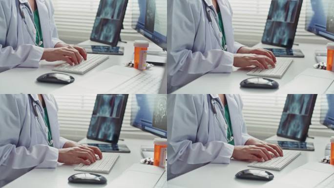 医生在医院办公桌上使用电脑，医疗保健和医学概念