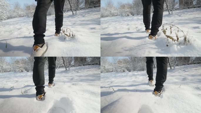 4k慢动作男子雪中行走前进脚步特写