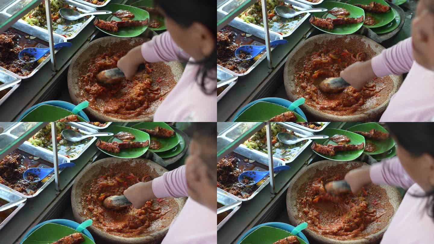 亚洲街头小贩用研钵和杵制作番茄酱
