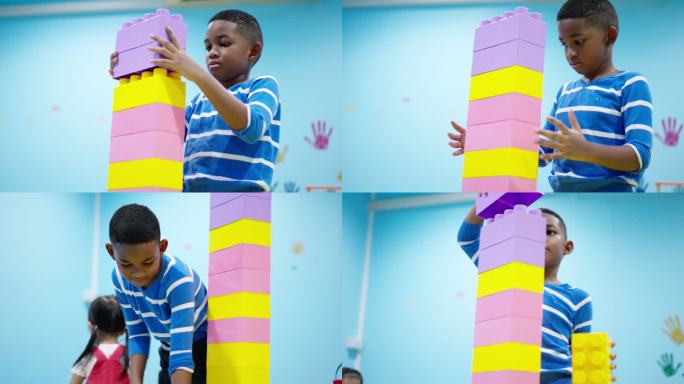 非洲黑人儿童，一个7岁的男孩试图将五颜六色的塑料积木尽可能高地连接起来，同时他需要意识到并保护建筑积