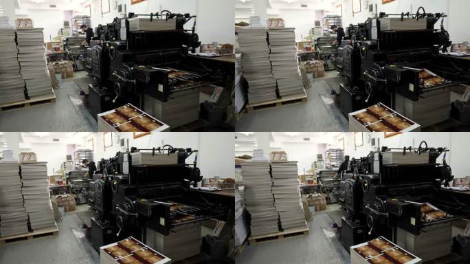 当工人在后台工作时，机器在Printing house里，分拣一堆印刷媒体