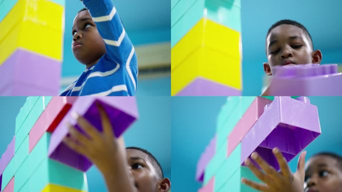 非洲黑人儿童的仰角，一个7岁的男孩打算连接并添加彩色塑料积木作为机器人，并需要保护它在客厅中不会倒塌
