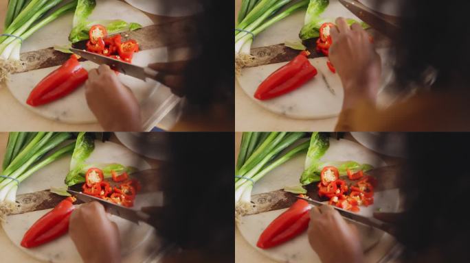 女人切红辣椒做饭案板