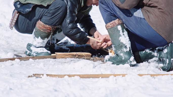 养羊。牧羊人在雪地里生火，近距离。