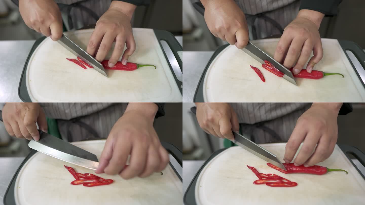 厨师将红辣椒切成小块，用作泰国食物的配料