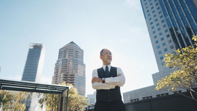 早上，一家亚洲中国公司的首席执行官交叉着双臂站在城市办公楼的屋顶上远眺